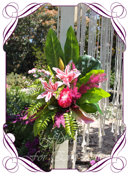A Gorgeous Silk Artificial Australian tropical arbor arch wedding table decoration featuring faux flower lilies, anthurium, fuchsia pink protea, plum peonies, monsteria, wedding decoration set. Made in Melbourne by Australia's Best Artificial Bridal Florist. Worldwide Shipping available