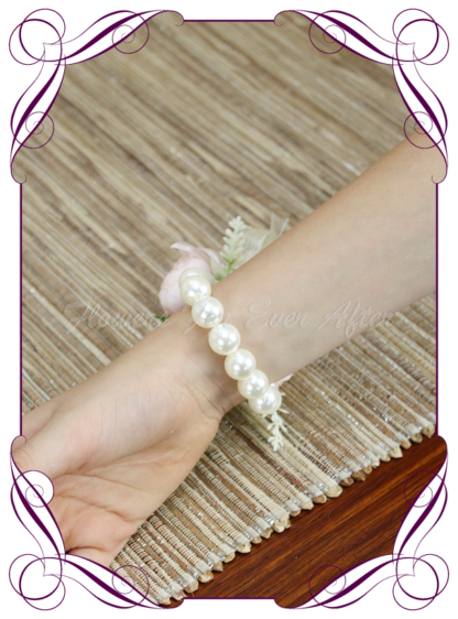 silk artificial childrens small ladies wrist corsage for wedding and formal / prom. Blush pink rose bud ivory white rose bud on pearl stretch bracelet. Made in Melbourne Australia. Buy online, shipping world wide.