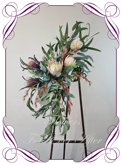 Realistic silk artificial fake flower rustic native Australian blush pink king protea, mauve purple banksia gum leaves cascading arbor corner arch decoration wedding decor. Made in Melbourne. Shipping world wide. Buy online