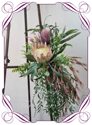 Realistic silk artificial fake flower rustic native Australian blush pink king protea, mauve purple banksia gum leaves cascading arbor corner arch decoration wedding decor. Made in Melbourne. Shipping world wide. Buy online