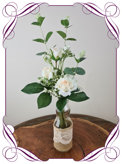 Silk artificial champagne blush roses and baby's breath and eucalypt gum bunch cluster table centrepiece decoration. Wedding table florals. simple white wedding rustic table centrepiece. Made in Australia. Buy online. Shipping world wide