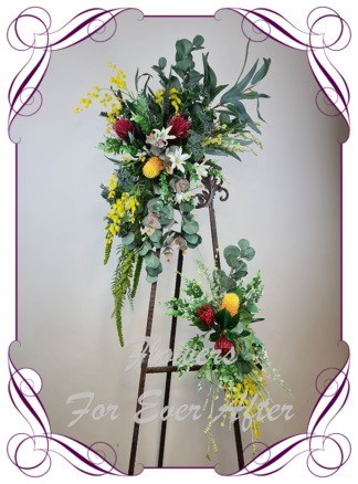 Silk artificial native Australian corner arbor arch backdrop floral decoration. Red, yellow, navy, orange, native Australian gum leaves foliage with banksia and wattle.Made in Melbourne Australia. Buy online, post worldwide.