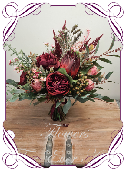 Silk artificial dark moody native Australian bridesmaid bouquet. Burgundy red and pink protea, berries, eucalypt. Made in Melbourne. Buy online. Shipping worldwide. Wedding bouquet ideas.