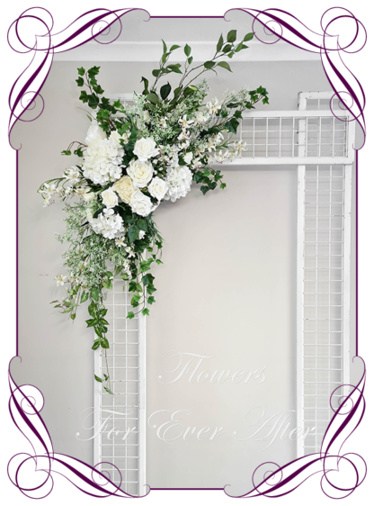 Silk artificial all white and foliage modern romantic wedding flowers wedding arbor arch background decoration. Hydrangea, white roses silk wedding florals, unusual romantic realistic fake wedding decoration design. Bridal table centrepiece flowers. Made in Melbourne Australia. Buy online..