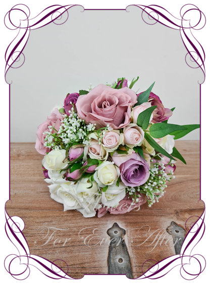 Silk artificial wedding bouquet ideas. Purple Mauve Lilac Pink and ivory white roses and baby's breath cascade tear bridal bouquet wedding posy set flowers. Elegant romantic wedding bridal bouquet. Made in Melbourne. Buy online. Shipping worldwide.