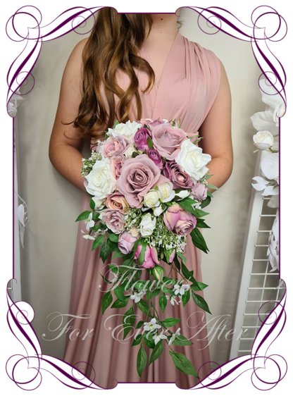 Silk artificial wedding bouquet ideas. Purple Mauve Lilac Pink and ivory white roses and baby's breath cascade tear bridal bouquet wedding posy set flowers. Elegant romantic wedding bridal bouquet. Made in Melbourne. Buy online. Shipping worldwide.