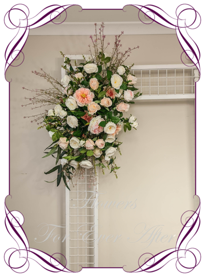 Silk artificial ceremony florals in peach pink apricot coral white and cream wedding flowers wedding arbor arch background decoration. Roses and peonies wedding ceremony silk wedding florals, unusual romantic realistic fake wedding decoration design. Bridal table centrepiece flowers. Made in Melbourne Australia. Buy online..