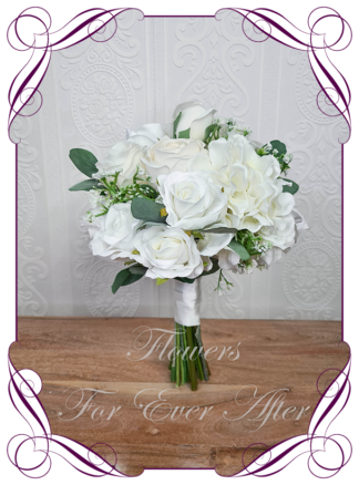 Silk artificial wedding bouquet ideas. Mixed ivory white faux silk bridal bouquet wedding flowers. Roses, peonies, ranunculus, baby's breath, eucalypt gum leaves foliage. Elegant romantic wedding posy bouquet. Made in Melbourne. Buy online. Shipping worldwide.