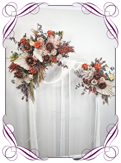 Silk Wedding ceremony arbour flowers package in artificial rust orange and brown Autumn arbor florals. Décor for wedding ceremony backdrop decoration. Faux Roses, pampas, and palm. Buy online now. Shipping world wide. Cheap wedding arbor decoration ideas.