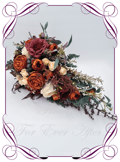 Silk Tear cascading Bridal Bouquet in realistic burgundy, rust burnt orange, peach and cream faux flowers. Bridal posy, featuring artificial roses, ranunculus, berries, eucalypt, flowers in a romantic elegant and unusual bridal style modern rustic wedding bouquets. Made in Melbourne by Australia's Best Artificial Bridal Florist. Buy online now. Worldwide Shipping available