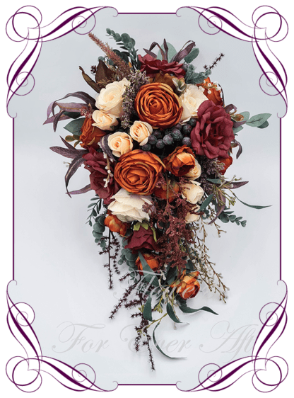 Silk Tear cascading Bridal Bouquet in realistic burgundy, rust burnt orange, peach and cream faux flowers. Bridal posy, featuring artificial roses, ranunculus, berries, eucalypt, flowers in a romantic elegant and unusual bridal style modern rustic wedding bouquets. Made in Melbourne by Australia's Best Artificial Bridal Florist. Buy online now. Worldwide Shipping available